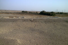Desert landscape at the edge of the railway line between Al Faiyum and Al Wasta in Egypt.