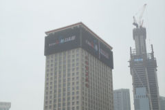 Screens on high-rise buidlings in the city centre of Dalian, China