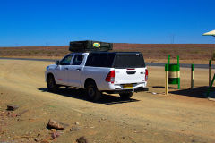 Car at a rest stop in the Kalahari Desert in Namibia