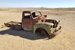 An old shooted car on the road to Ais-Ais in the Fish River Canyon Namibia