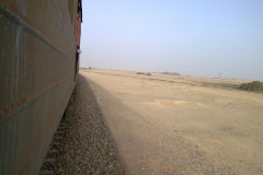 Desert landscape at the edge of the railway line between Al Faiyum and Al Wasta in Egypt.