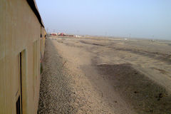 Desert landscape at the edge of the railway line between Al Faiyum and Al Wasta in Egypt.